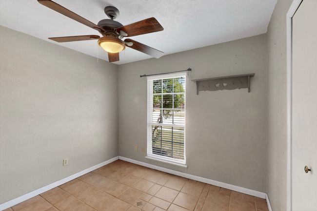 Unfurnished room with light tile patterned floors and ceiling fan | Image 13