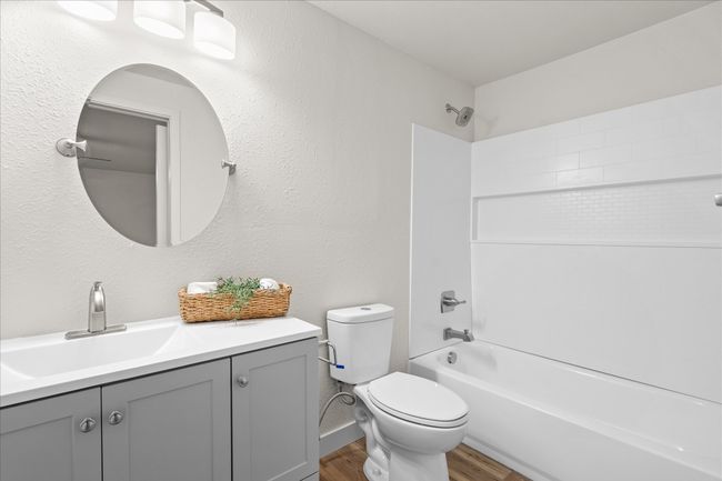Bathroom featuring wood finished floors, vanity, and shower / washtub combination | Image 15