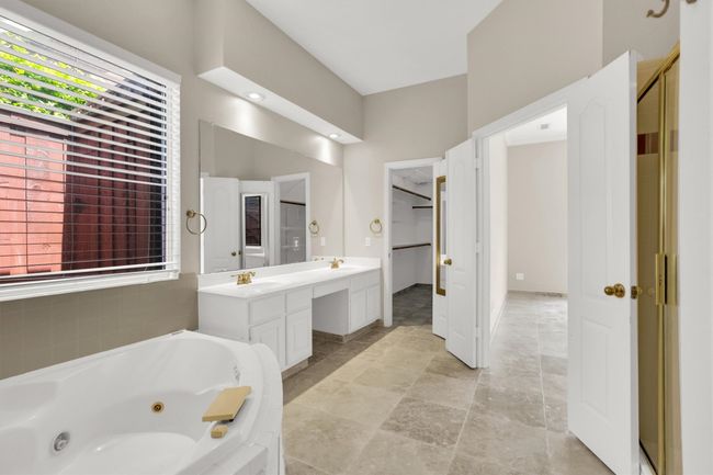 Full bath featuring a wealth of natural light, a sink, double vanity, and a tub with jets | Image 29