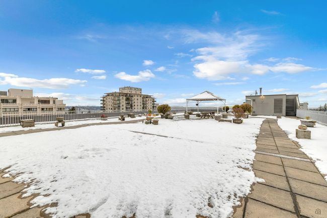 Yard covered in snow with a gazebo and fence | Image 29