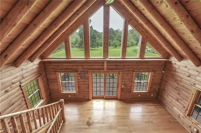 View from the second floor loft overlooking the great room and windows looking out over the back of the property | Image 30