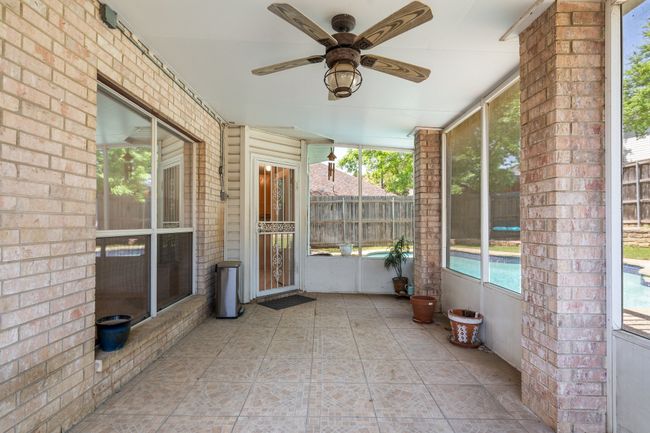 Unfurnished sunroom with a healthy amount of sunlight and ceiling fan | Image 27