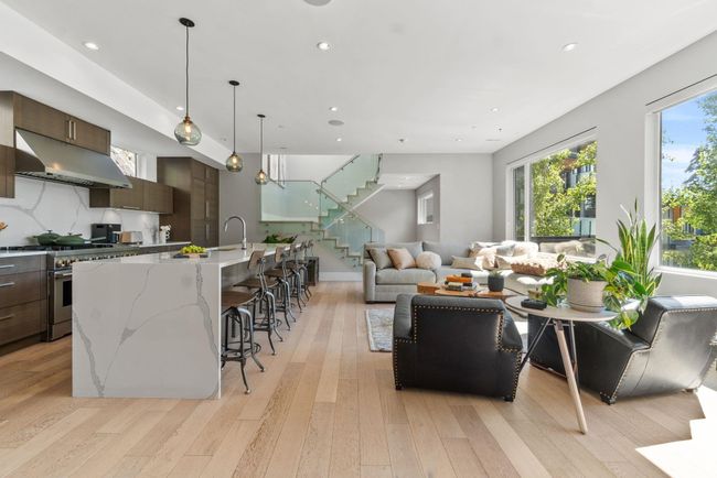 Living room featuring stairs, light wood-style flooring, and recessed lighting | Image 5