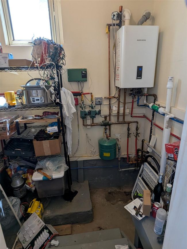 Utilities with tankless water heater on a lower level | Image 18