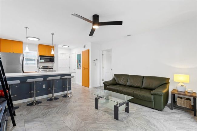 Living area featuring ceiling fan | Image 12