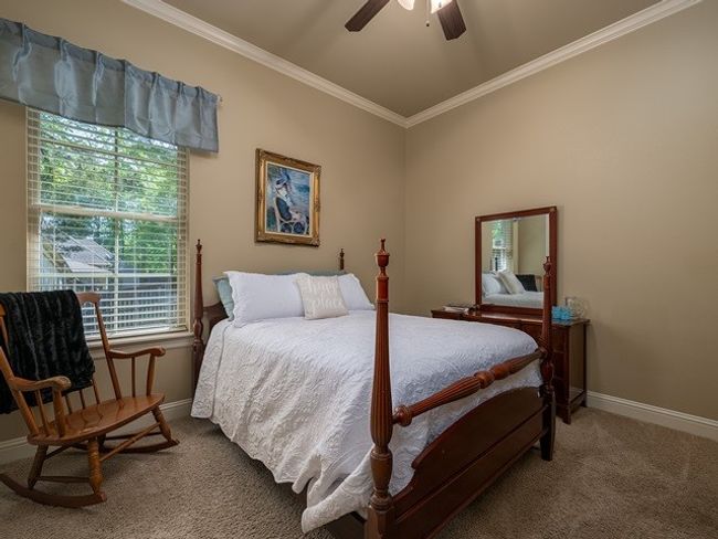 Carpeted bedroom with a ceiling fan, baseboards, and crown molding | Image 30
