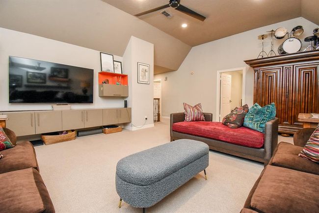 Notice the bank of storage under the television. This is well sized game room! Room for a game table too! | Image 33