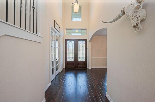 Welcome guests in style with this elegant foyer, featuring high ceilings, rich wood floors, and abundant natural light. | Image 5
