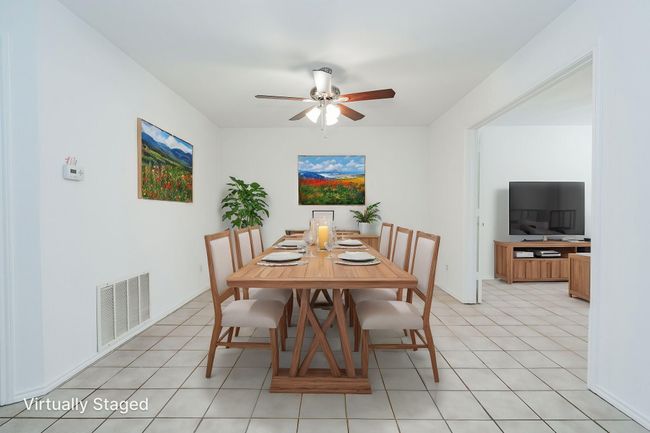 Dining space with visible vents and ceiling fan | Image 7