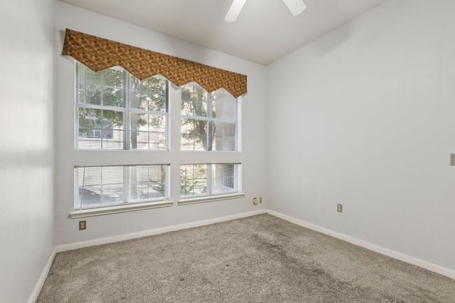 Carpeted spare room featuring baseboards and a ceiling fan | Image 21