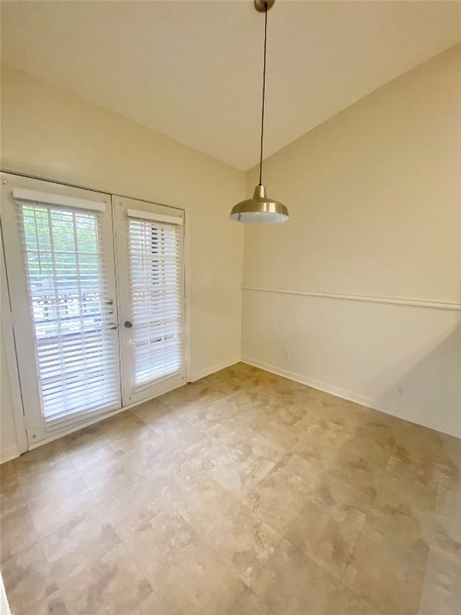 Unfurnished dining area featuring baseboards and lofted ceiling | Image 17