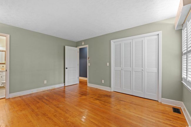 Unfurnished bedroom with baseboards, a closet, visible vents, and light wood-type flooring | Image 10