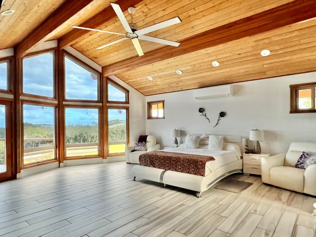 Exquisite primary bedroom opens to wrap-around deck. Split system air conditioning. | Image 11