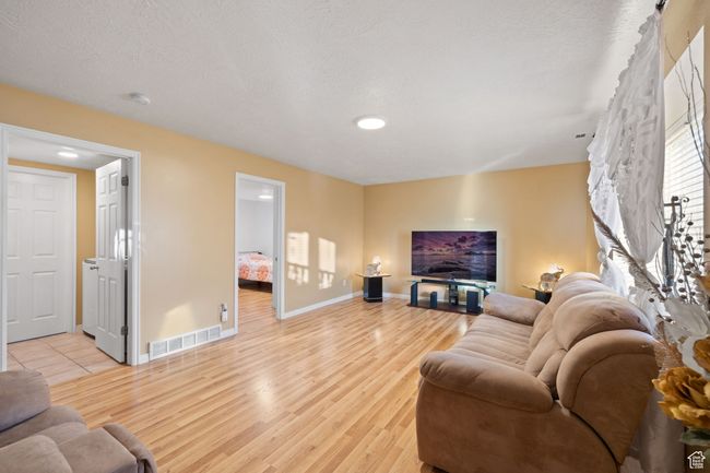 Living room featuring light hardwood / wood-style flooring and a textured ceiling | Image 29