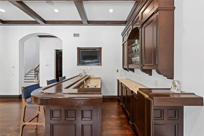 Dining space featuring dark parquet flooring, crown molding, and an inviting chandelier | Image 12