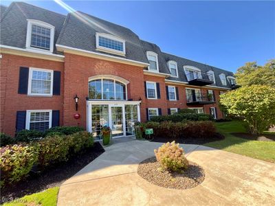 View of front of property featuring a balcony and a front yard | Image 2