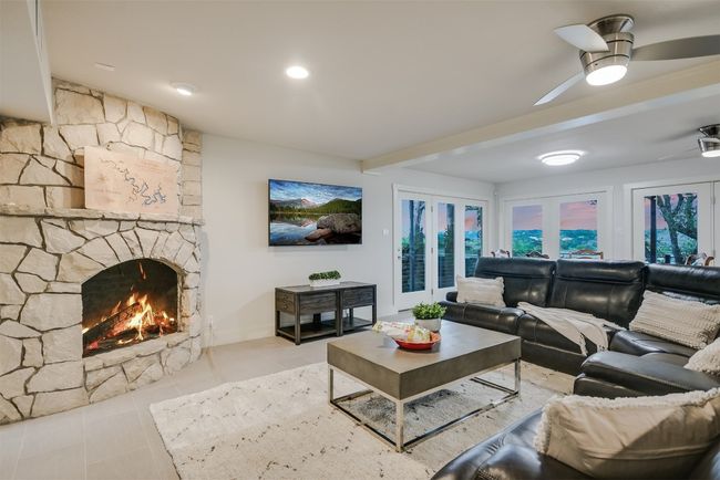 The secondary living room, with its own fireplace, offers a cozy space for family movie nights or quiet relaxation | Image 13