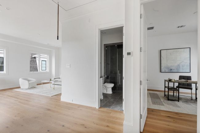 Lovely flexible top floor features the third bedroom as well as game room with wide doors open to the entertaining patio. | Image 28