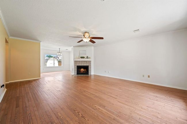 Large family living area, surrounded by crown molding | Image 6