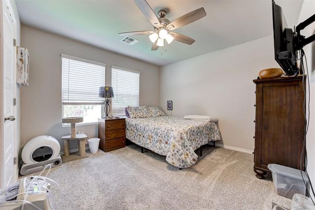 Bedroom with light colored carpet and ceiling fan | Image 35