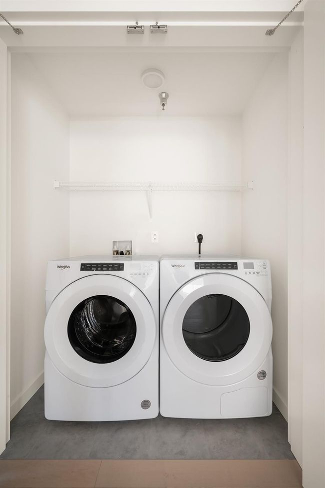 Laundry room with separate washer and dryer and tile patterned floors | Image 12