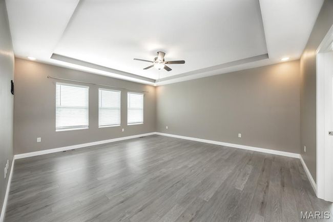 Tray ceiling with fan and LVP flooring | Image 14