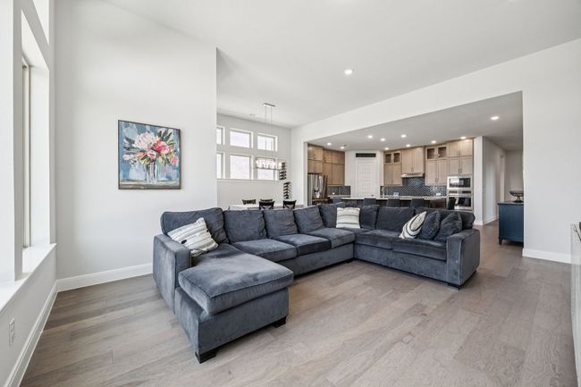 Living area featuring light wood finished floors, baseboards, and recessed lighting | Image 23
