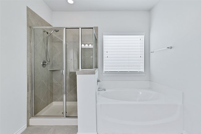 Full bath with a bath, a stall shower, and tile patterned floors | Image 16