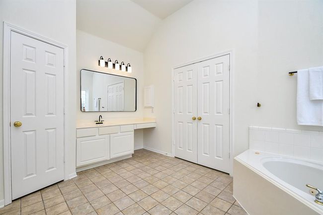Your primary bathroom is also complete with a huge walk-in closet with built-in shelving all the way to the top - maximizing every square inch for your well-loved pieces! | Image 20