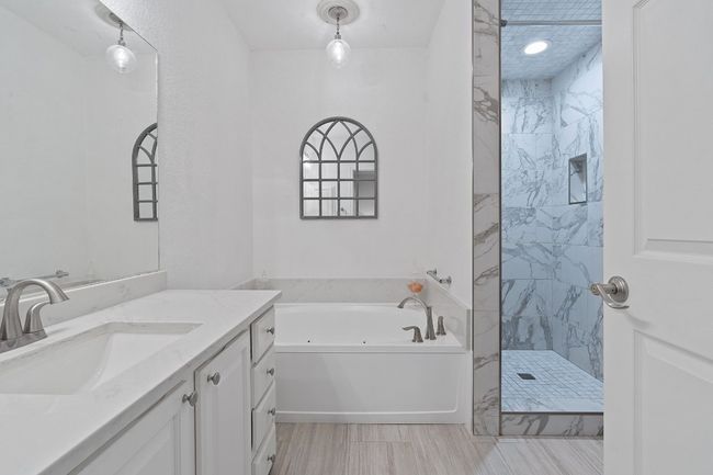 Beautiful, spacious Main bathroom with new countertops, floors, jacuzzi tub and shower | Image 18
