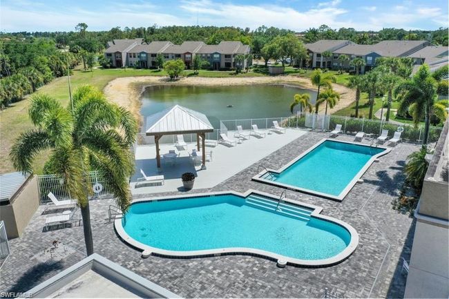 Pool featuring fence, a gazebo, a water view, and a patio | Image 34
