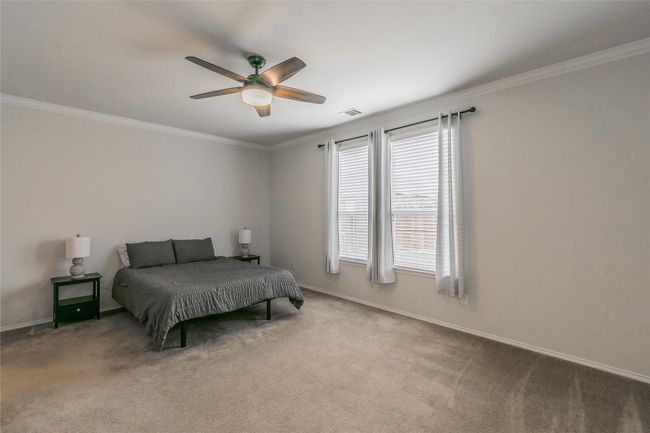 Carpeted Main bedroom with ornamental molding and ceiling fan | Image 26