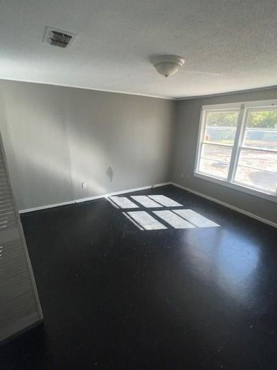 Unfurnished room featuring a textured ceiling | Image 3