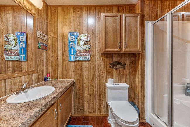 Full bath with wooden walls, a shower stall, and vanity | Image 21
