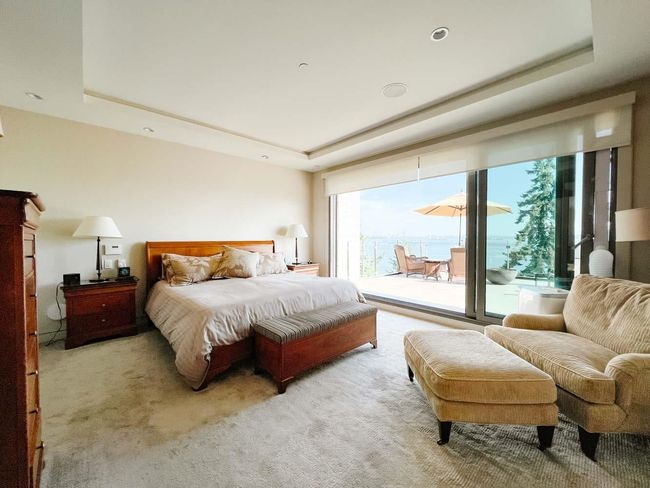 Bedroom featuring a raised ceiling, access to outside, and carpet floors | Image 34