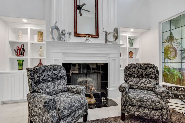 Sitting room featuring a tiled fireplace, light marble finish flooring, and ceiling fan | Image 10
