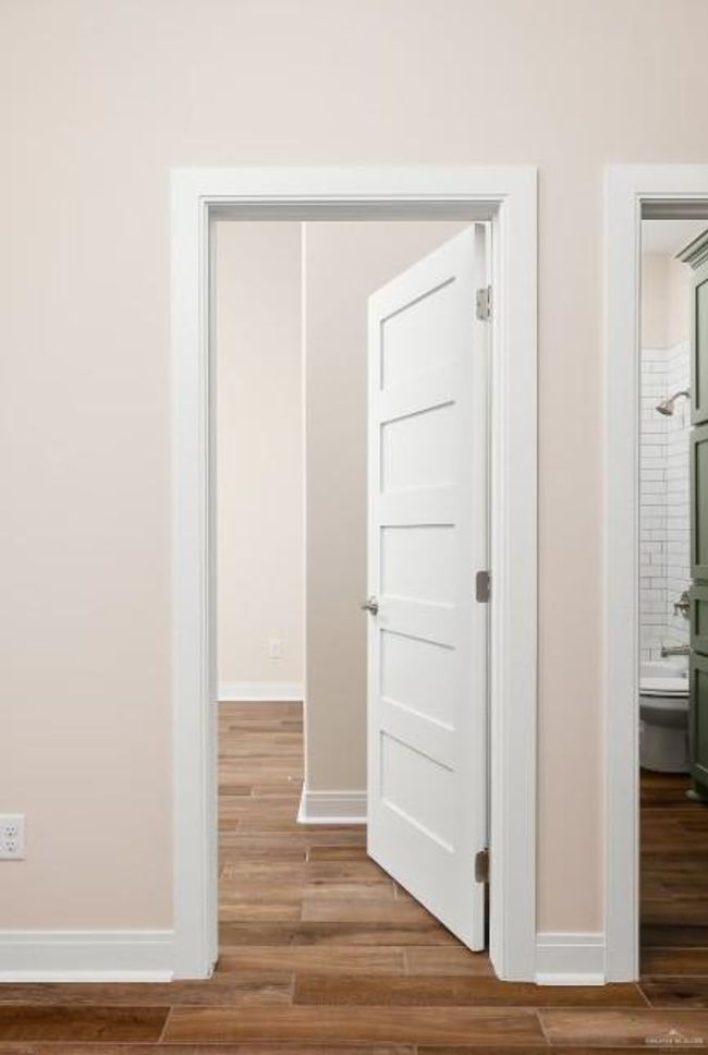 Hall featuring wood finished floors and baseboards | Image 13