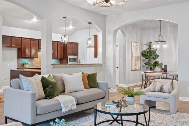 Living room featuring arched walkways, a chandelier, and baseboards | Image 12