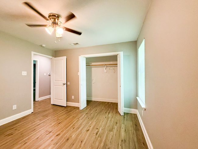 Unfurnished bedroom featuring light wood-style flooring, a closet, and ceiling fan | Image 9