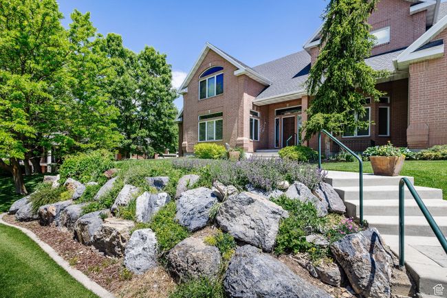 View of front of house with brick siding and a shingled roof | Image 77