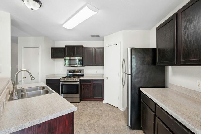 Kitchen featuring appliances with stainless steel finishes and light countertops | Image 8