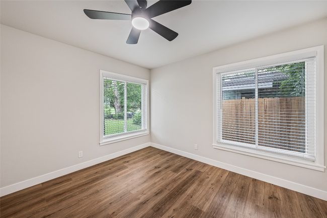 Spare room with wood finished floors and a ceiling fan | Image 8