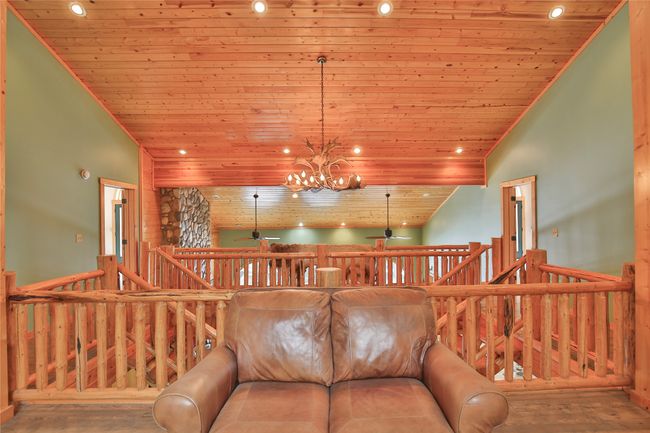 Living area featuring recessed lighting, high vaulted ceiling, wooden ceiling, and ceiling fan with notable chandelier | Image 38