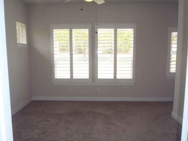 Empty room featuring ceiling fan, carpet floors, and healthy amount of natural light | Image 24