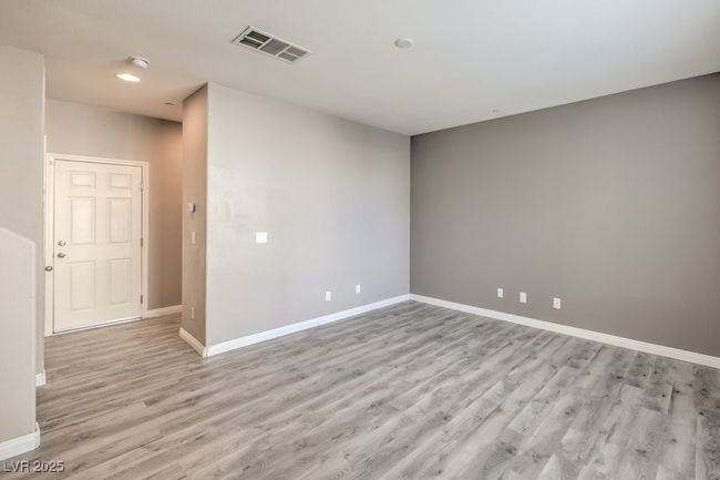 Empty room with baseboards, visible vents, and light wood-type flooring | Image 8