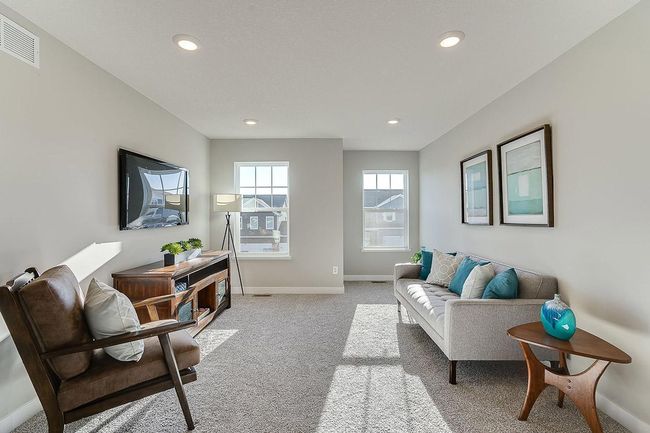 The home's upper level is equally impressive, as it features four bedrooms, two baths, laundry and this game room or loft area, which is sure to be a favorite hangout spot! Photo of model home, color and options will vary. | Image 11
