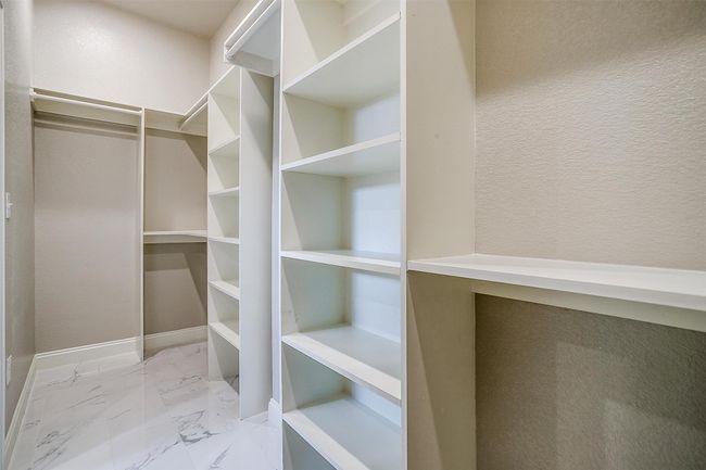 Walk in closet featuring marble finish floor | Image 22