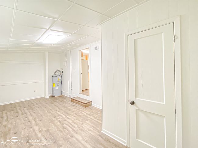 Basement featuring water heater and wood finished floors | Image 28