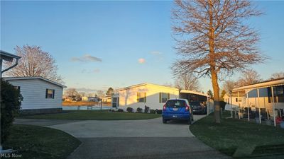 View of front of house with a carport and a front yard | Image 1