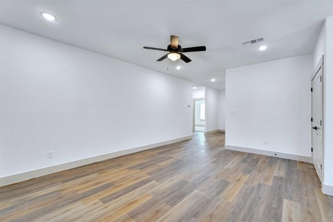 Empty room with visible vents, baseboards, a ceiling fan, recessed lighting, and light wood-style flooring | Image 18